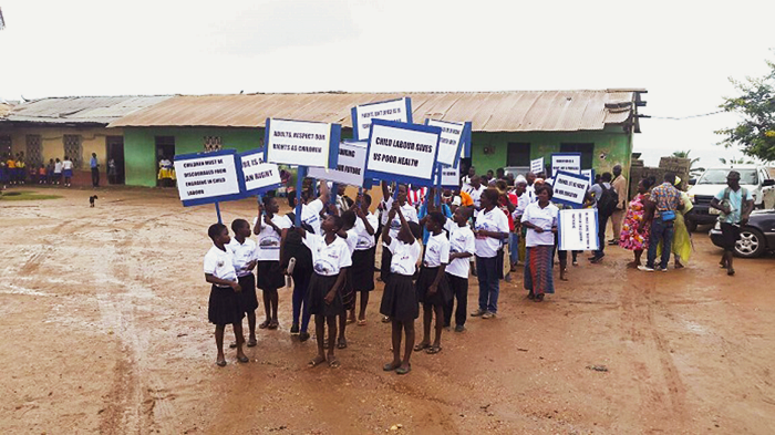Pupils from schools in Biriwa holding placards during a procession through the town, before the durbar Parents urged to help curb truancy among children